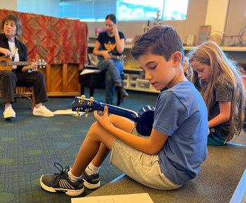 Students in music class learning to play the ukelele
